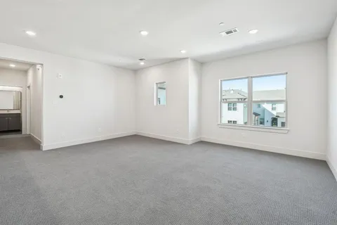 an empty room with a window and a bathroom