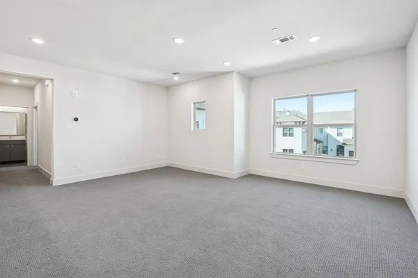 an empty room with a window and a bathroom