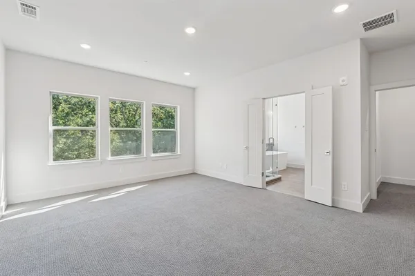 an empty room with large windows