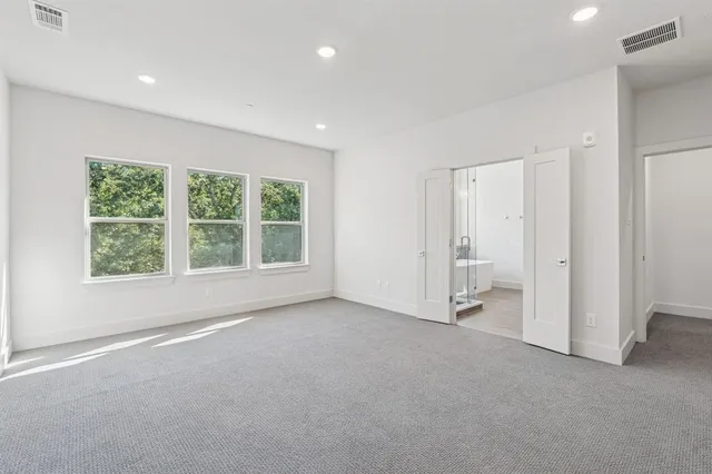 an empty room with large windows