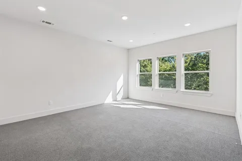 a spacious bathroom with a double vanity sink a mirror and a bathtub