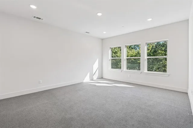 a spacious bathroom with a double vanity sink a mirror and a bathtub