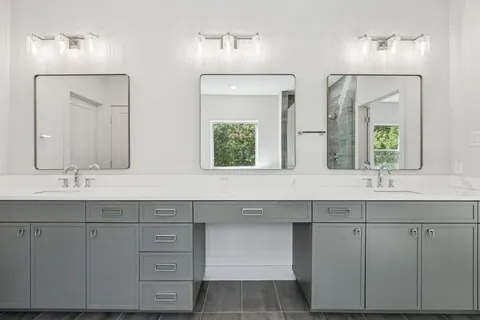 a bathroom with double sink and a large mirror