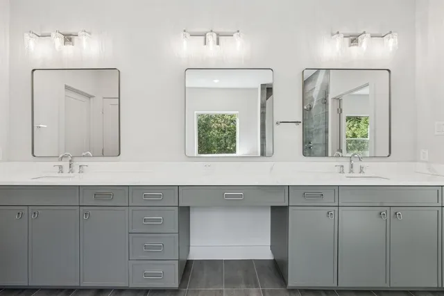 a bathroom with double sink and a large mirror