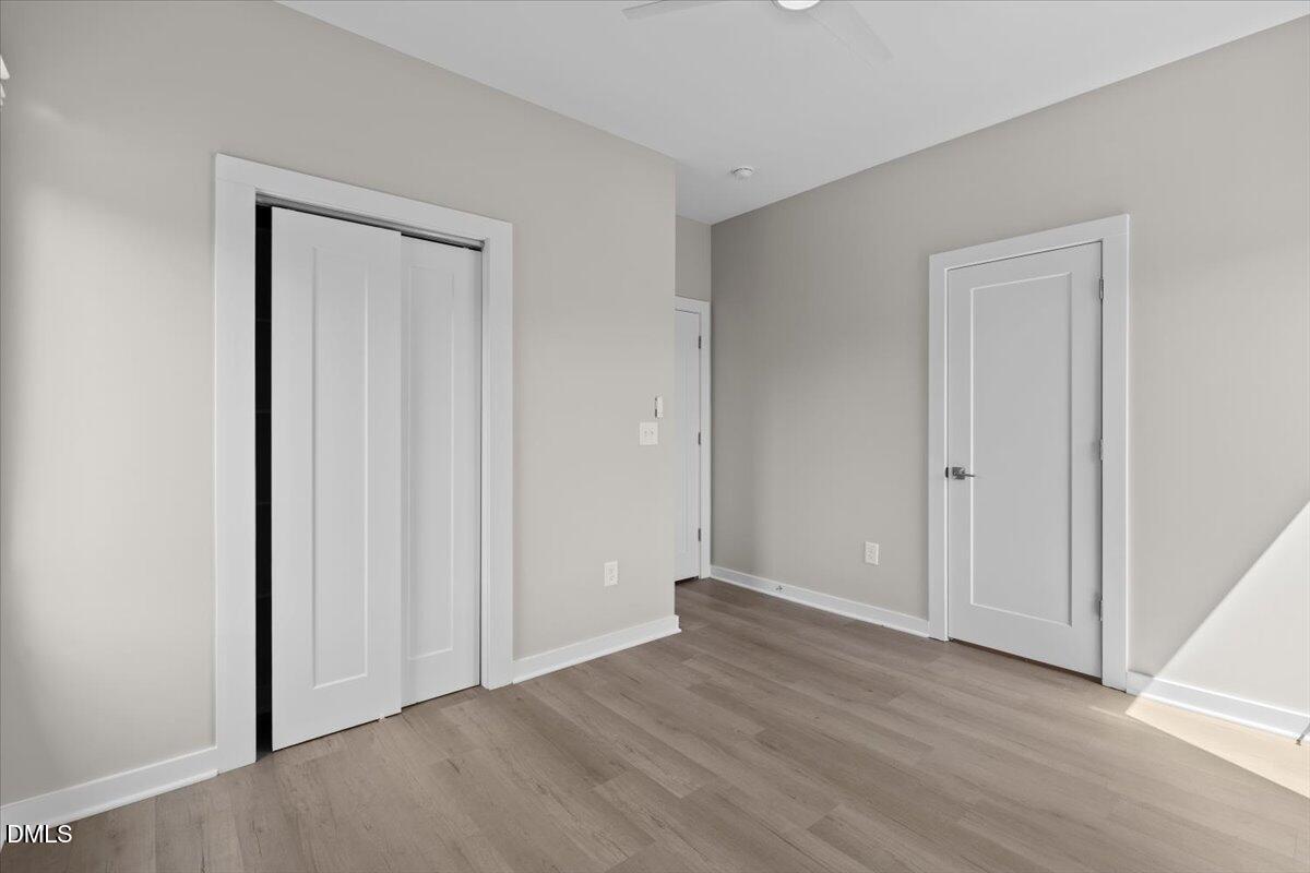 412 Commonwealth Street Durham, NC 27703 - Photo 14 of 24 a view of an empty room with wooden floor