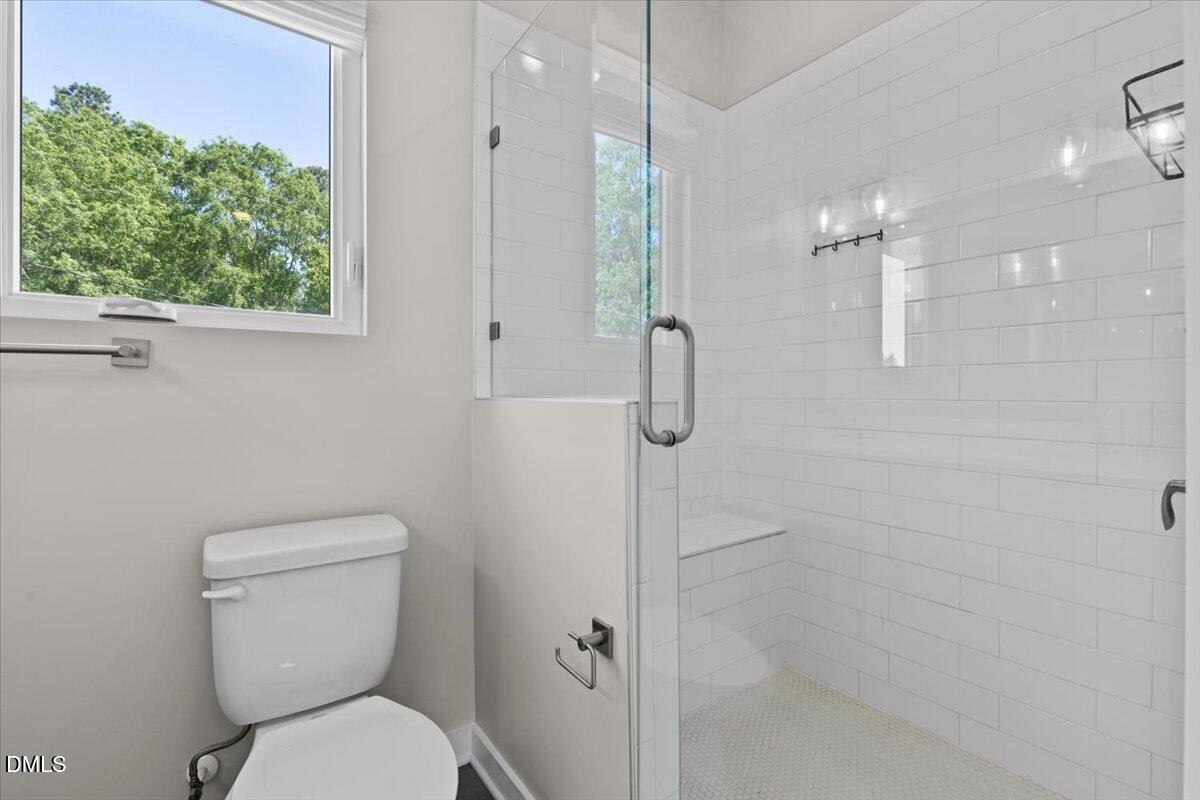 412 Commonwealth Street Durham, NC 27703 - Photo 17 of 24 a bathroom with a toilet and a shower