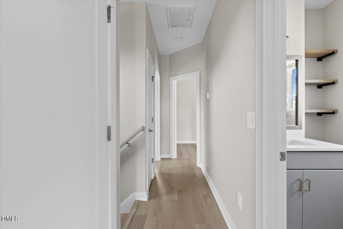 412 Commonwealth Street Durham, NC 27703 - Photo 18 of 24 a view of a hallway with a cabinet and a white cabinet