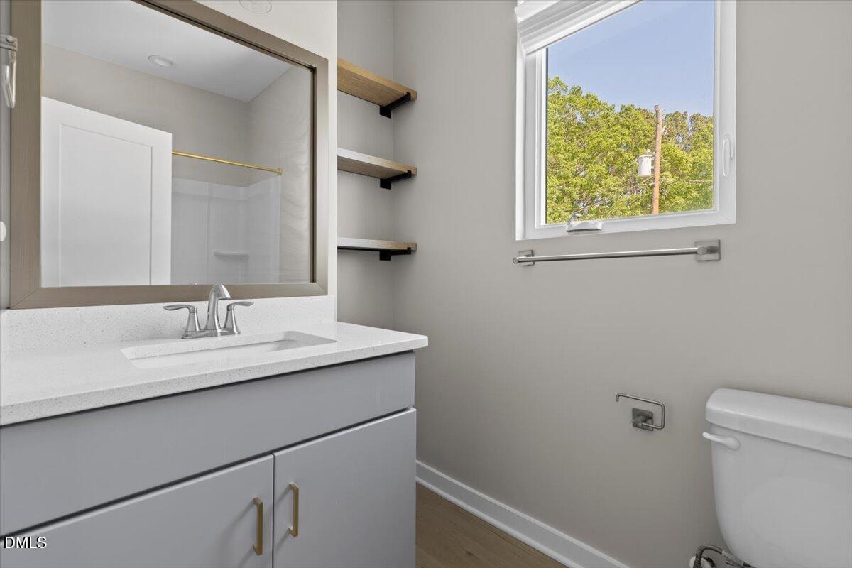412 Commonwealth Street Durham, NC 27703 - Photo 19 of 24 a bathroom with a sink and a toilet
