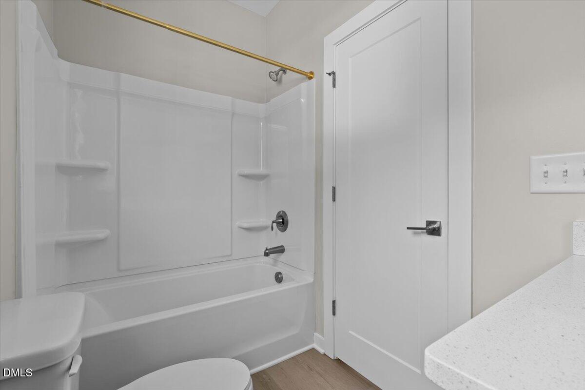 412 Commonwealth Street Durham, NC 27703 - Photo 20 of 24 a bathroom with a toilet and a bathtub