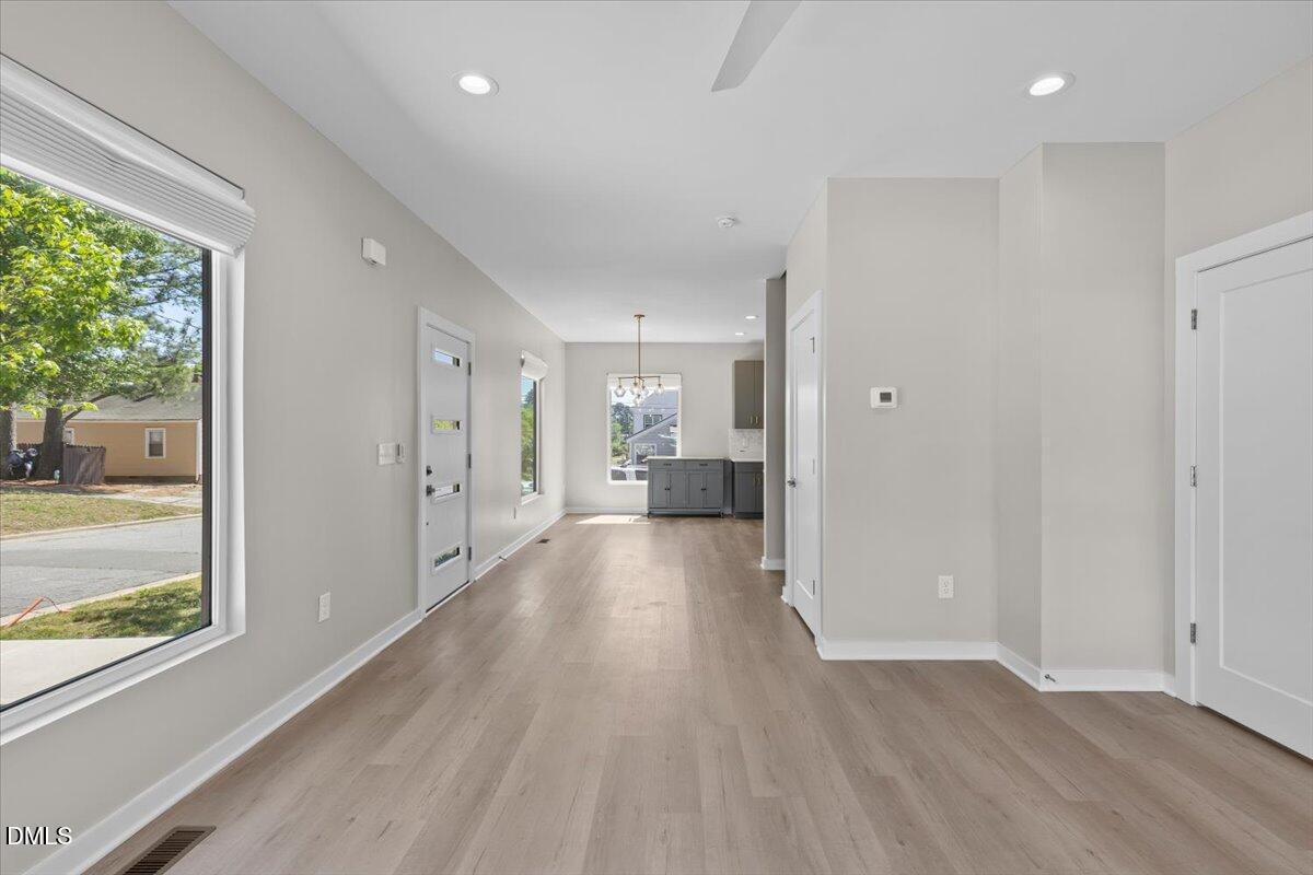 412 Commonwealth Street Durham, NC 27703 - Photo 5 of 24 a view of a big room with wooden floor and windows