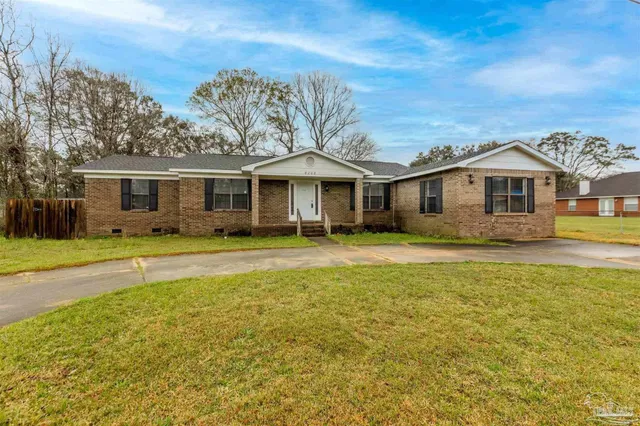 a front view of a house with a yard table and chairs