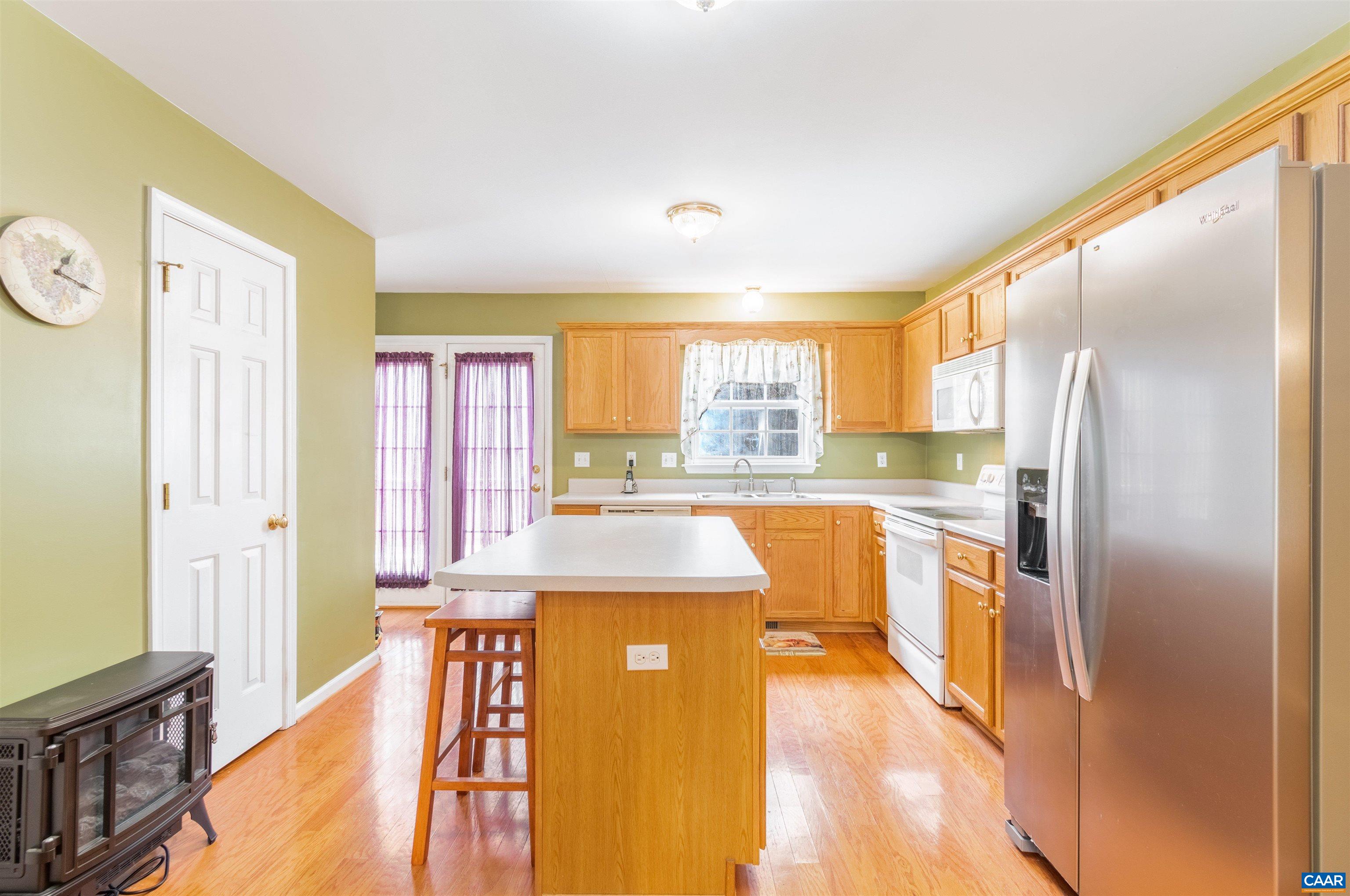 46 Lilac Road Ruckersville, VA 22968 - Photo 12 of 26 a large kitchen with a large window a refrigerator and a counter space