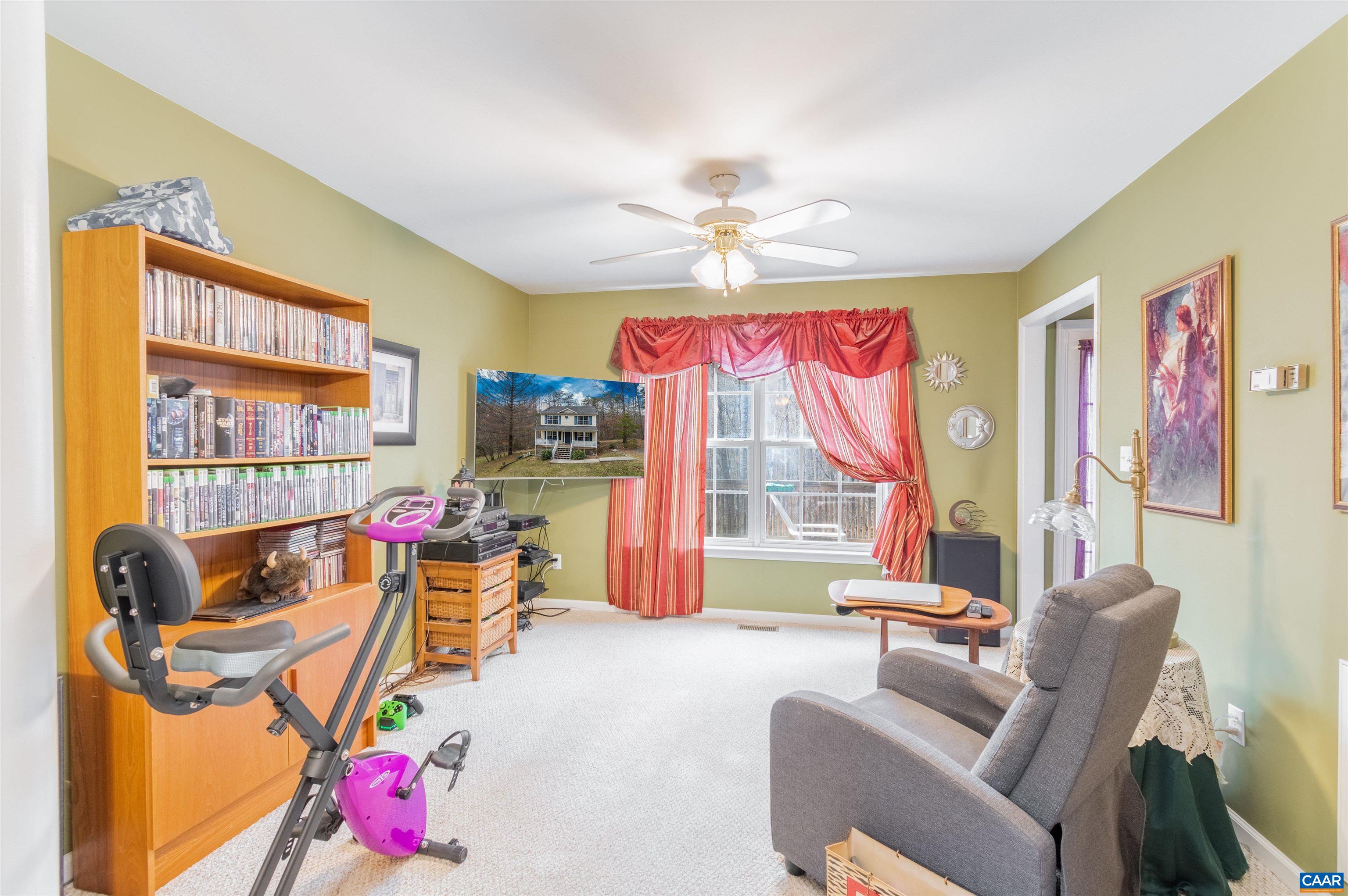 46 Lilac Road Ruckersville, VA 22968 - Photo 16 of 26 a living room with furniture a flat screen tv and a large window