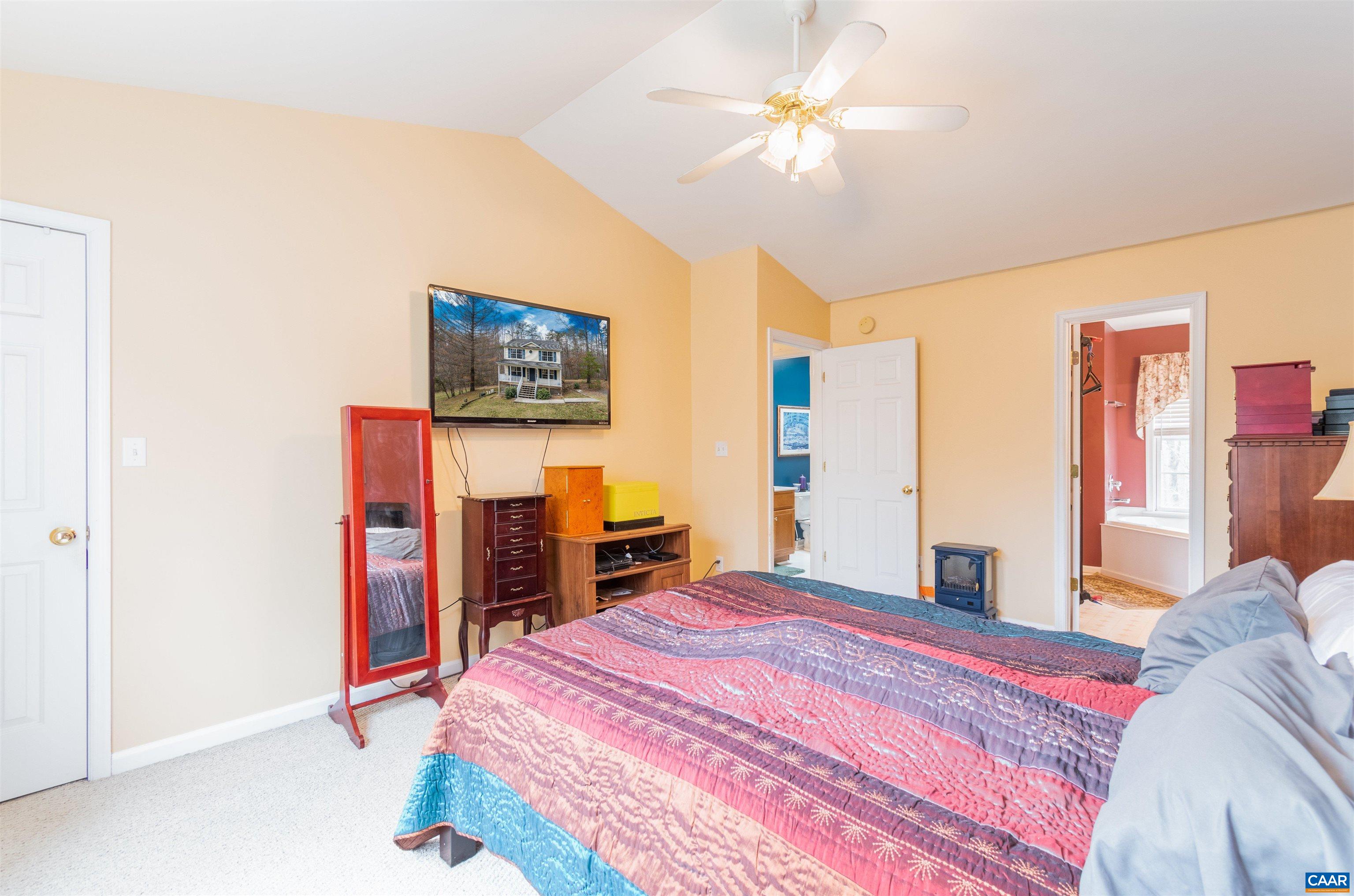 46 Lilac Road Ruckersville, VA 22968 - Photo 17 of 26 a bedroom with a bed and a chandelier