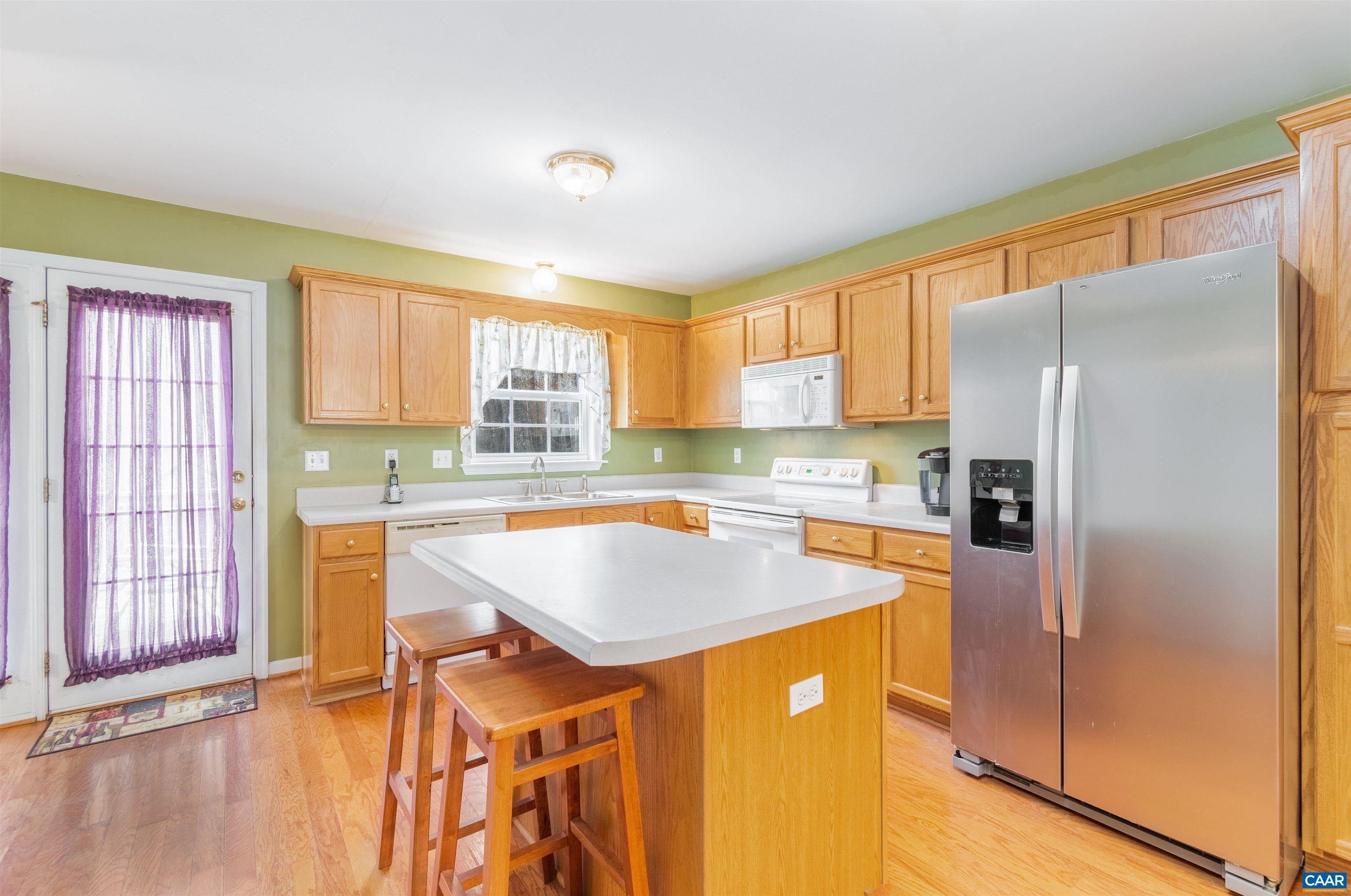 46 Lilac Road Ruckersville, VA 22968 - Photo 3 of 26 a kitchen with stainless steel appliances granite countertop a refrigerator a sink a stove and island