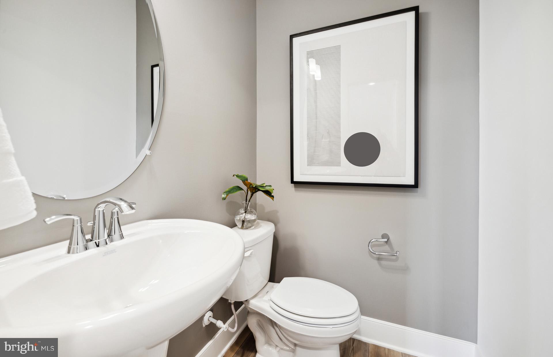 14495 Leafhopper Drive Boyds, MD 20841 - Photo 7 of 37 a bathroom with a toilet a sink and mirror
