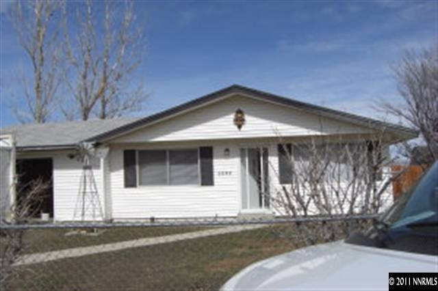 9415 Fremont Way Reno, NV 89506 - Photo 2 of 13 a front view of a house with a yard
