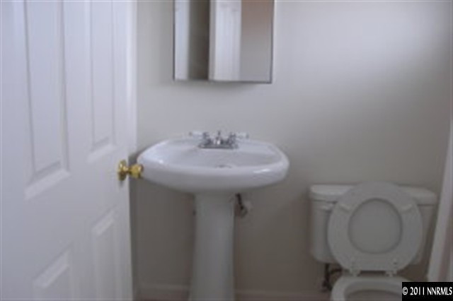 9415 Fremont Way Reno, NV 89506 - Photo 7 of 13 a bathroom with a toilet sink and mirror