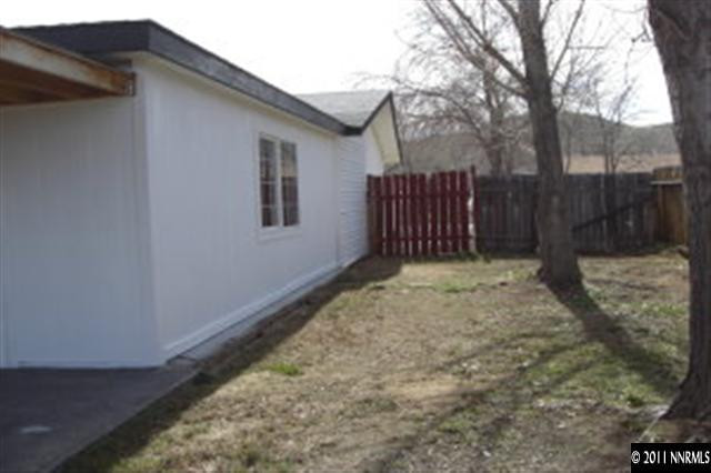 9415 Fremont Way Reno, NV 89506 - Photo 10 of 13 a view of backyard with a large tree and wooden fence