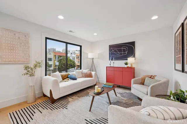 a living room with furniture and a large window