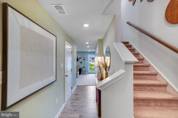 a view of entryway and hall with wooden floor