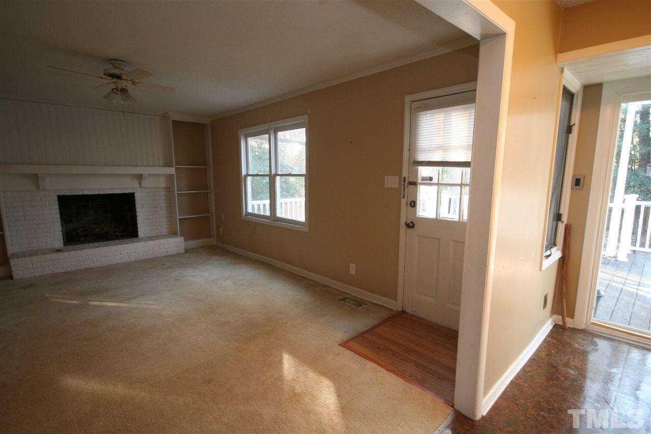 5821 Morning Forest Drive Raleigh, NC 27609 - Photo 11 of 25 a view of an empty room with windows and a fireplace