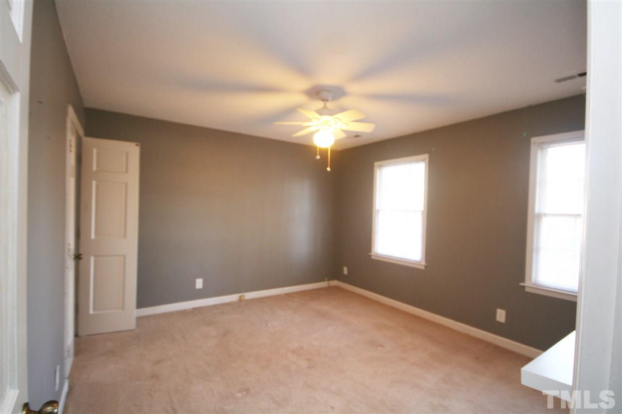 5821 Morning Forest Drive Raleigh, NC 27609 - Photo 17 of 25 an empty room with windows and fan