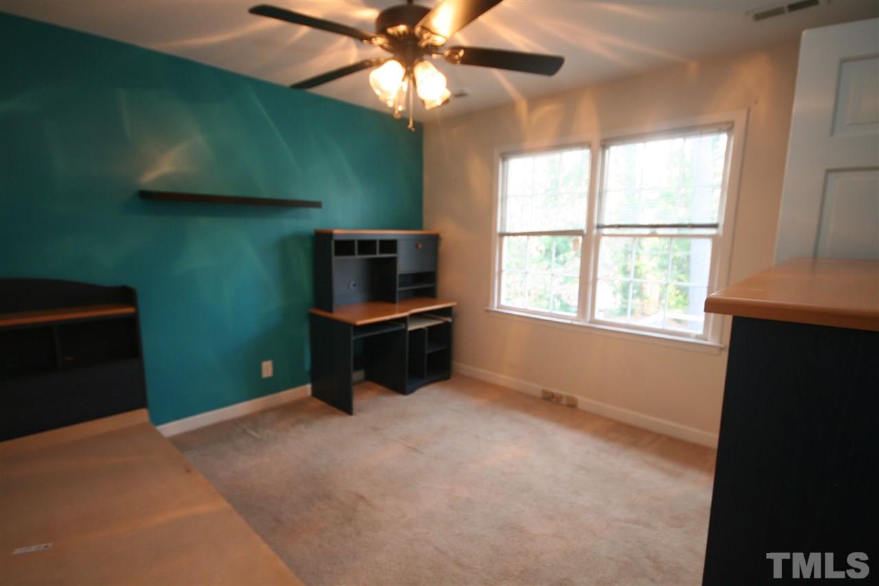 5821 Morning Forest Drive Raleigh, NC 27609 - Photo 18 of 25 a bedroom with window and a ceiling fan