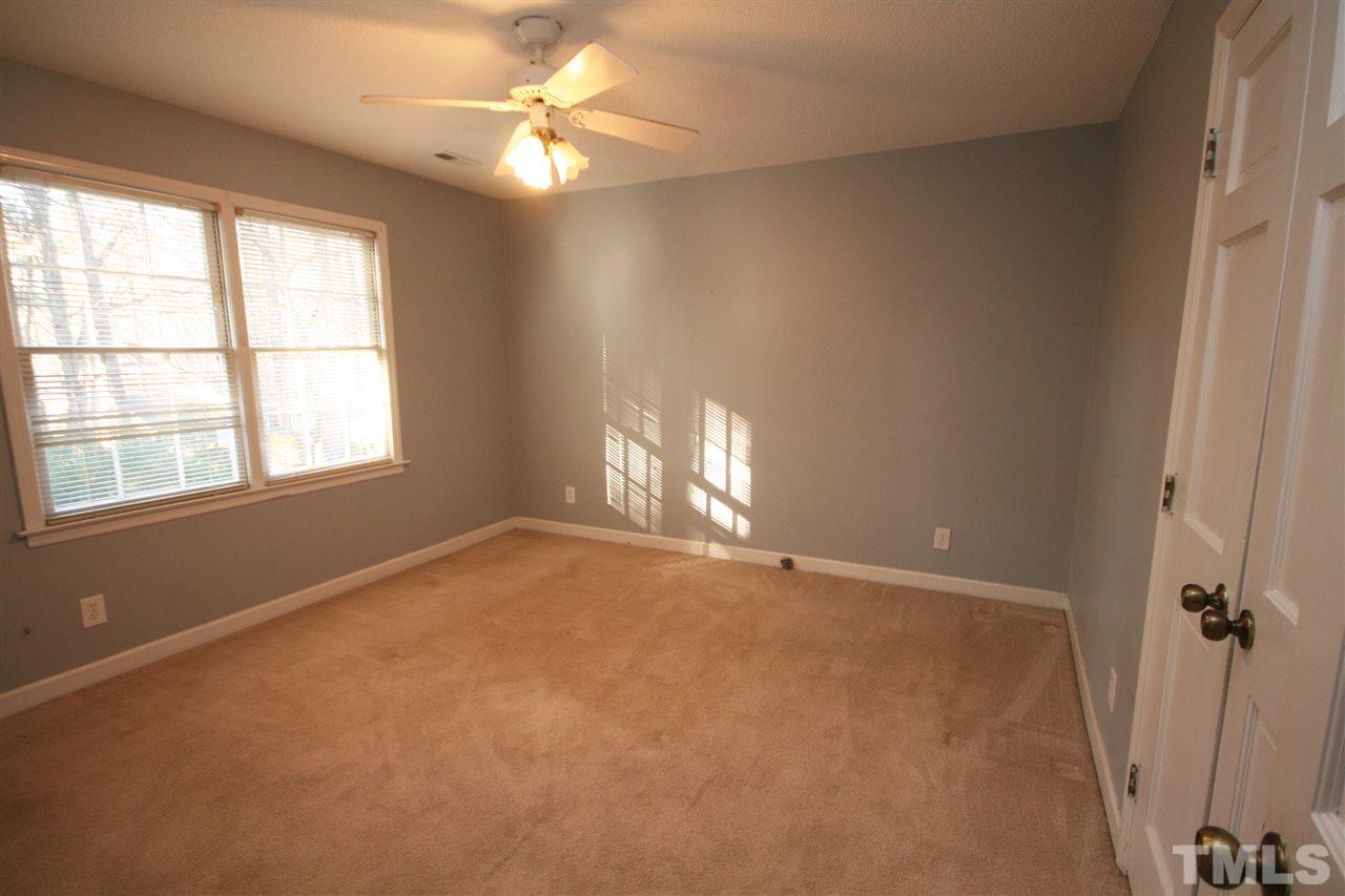 5821 Morning Forest Drive Raleigh, NC 27609 - Photo 19 of 25 an empty room with windows and chandelier fan
