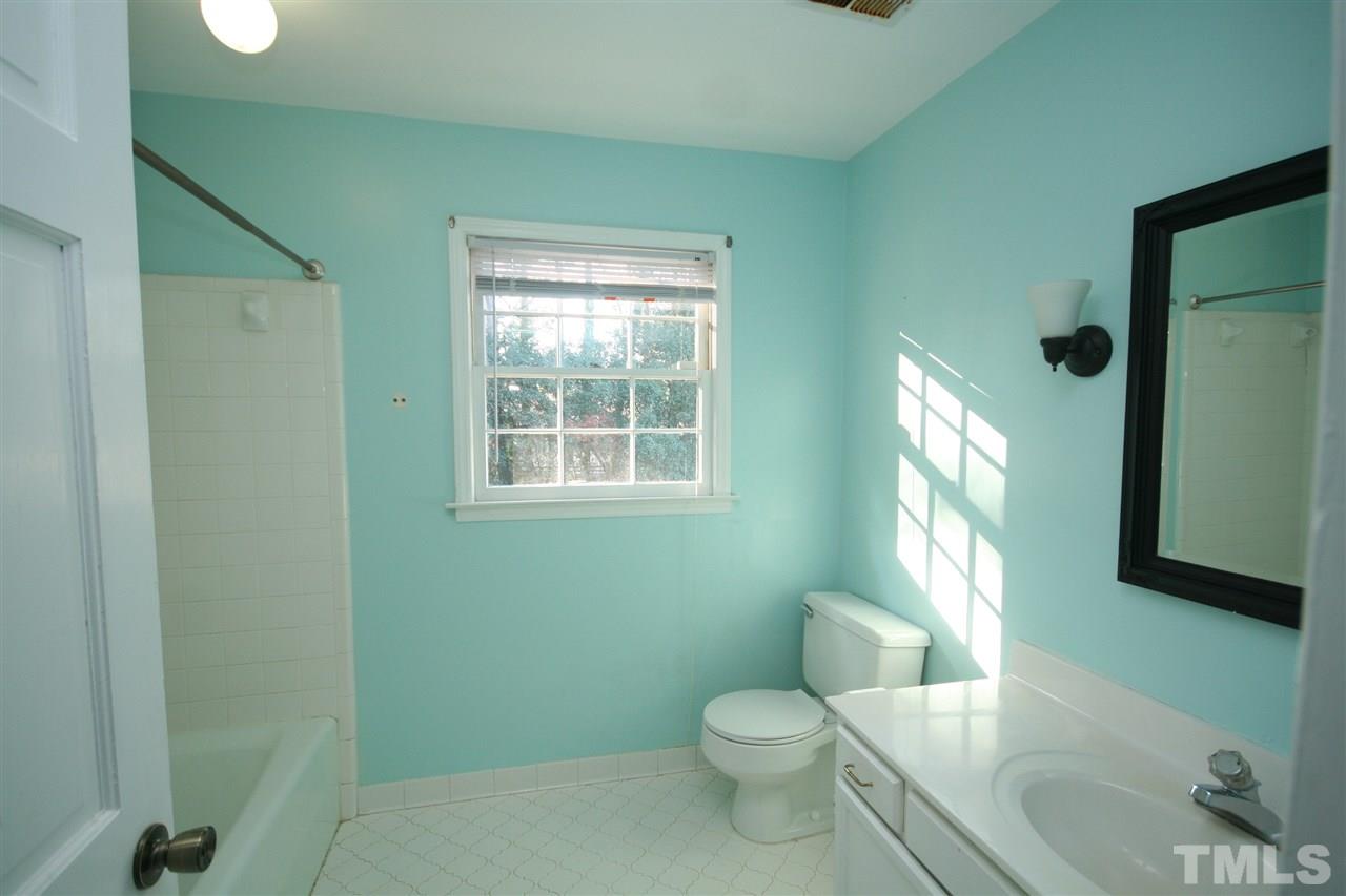5821 Morning Forest Drive Raleigh, NC 27609 - Photo 21 of 25 a bathroom with a toilet sink and window