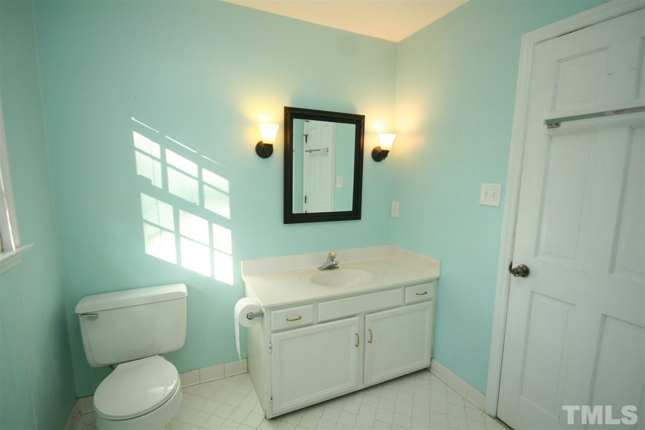 5821 Morning Forest Drive Raleigh, NC 27609 - Photo 22 of 25 a bathroom with a toilet sink and mirror