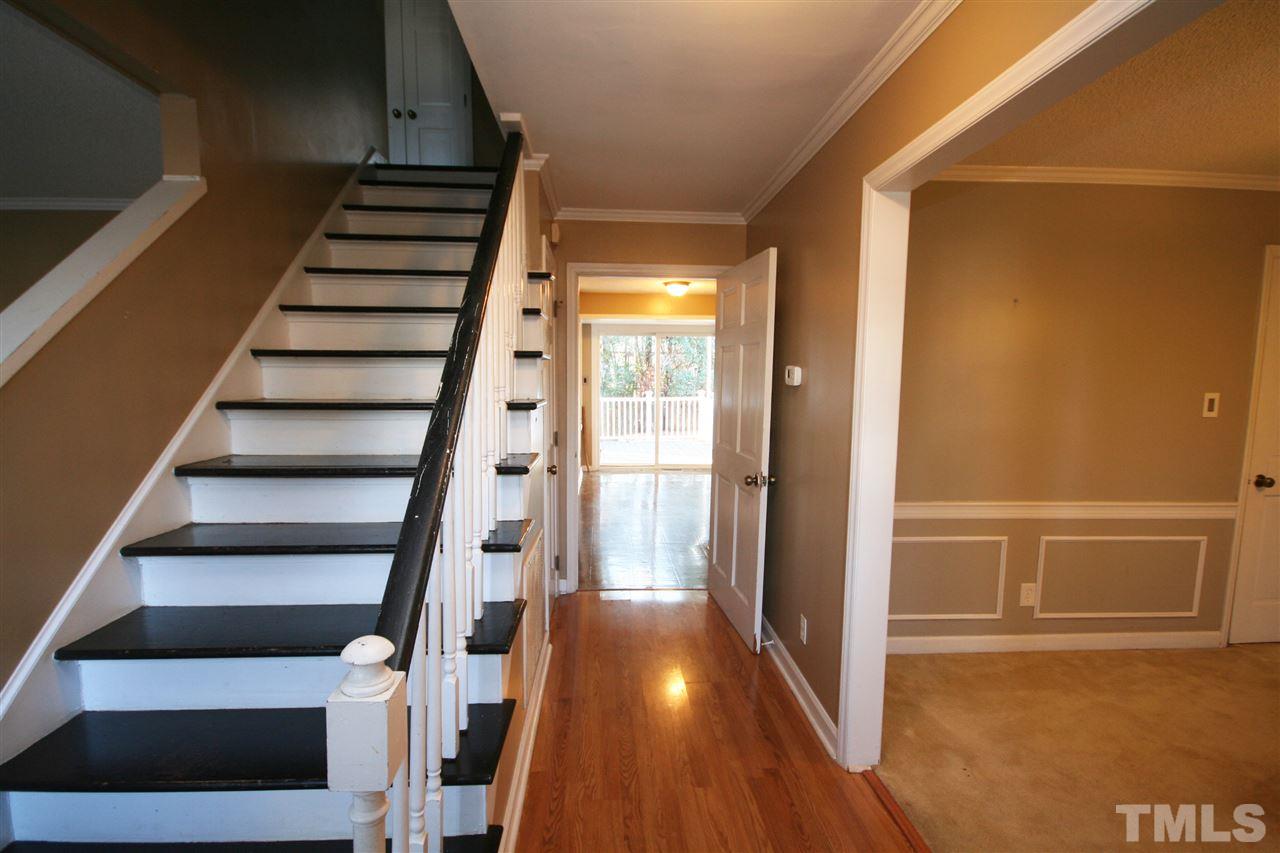 5821 Morning Forest Drive Raleigh, NC 27609 - Photo 5 of 25 a view of staircase with wooden floor and white walls