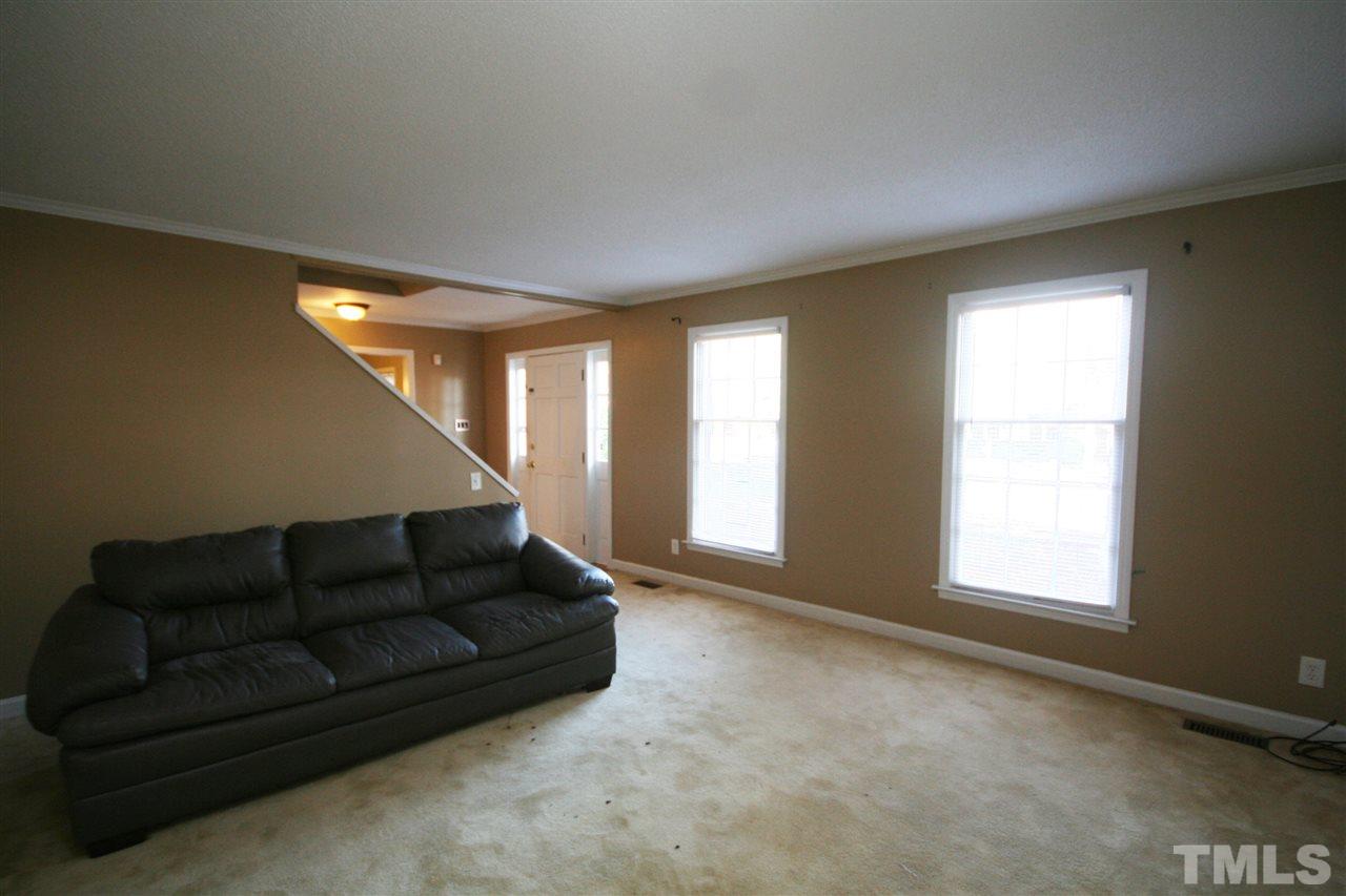 5821 Morning Forest Drive Raleigh, NC 27609 - Photo 8 of 25 a living room with furniture and a large window