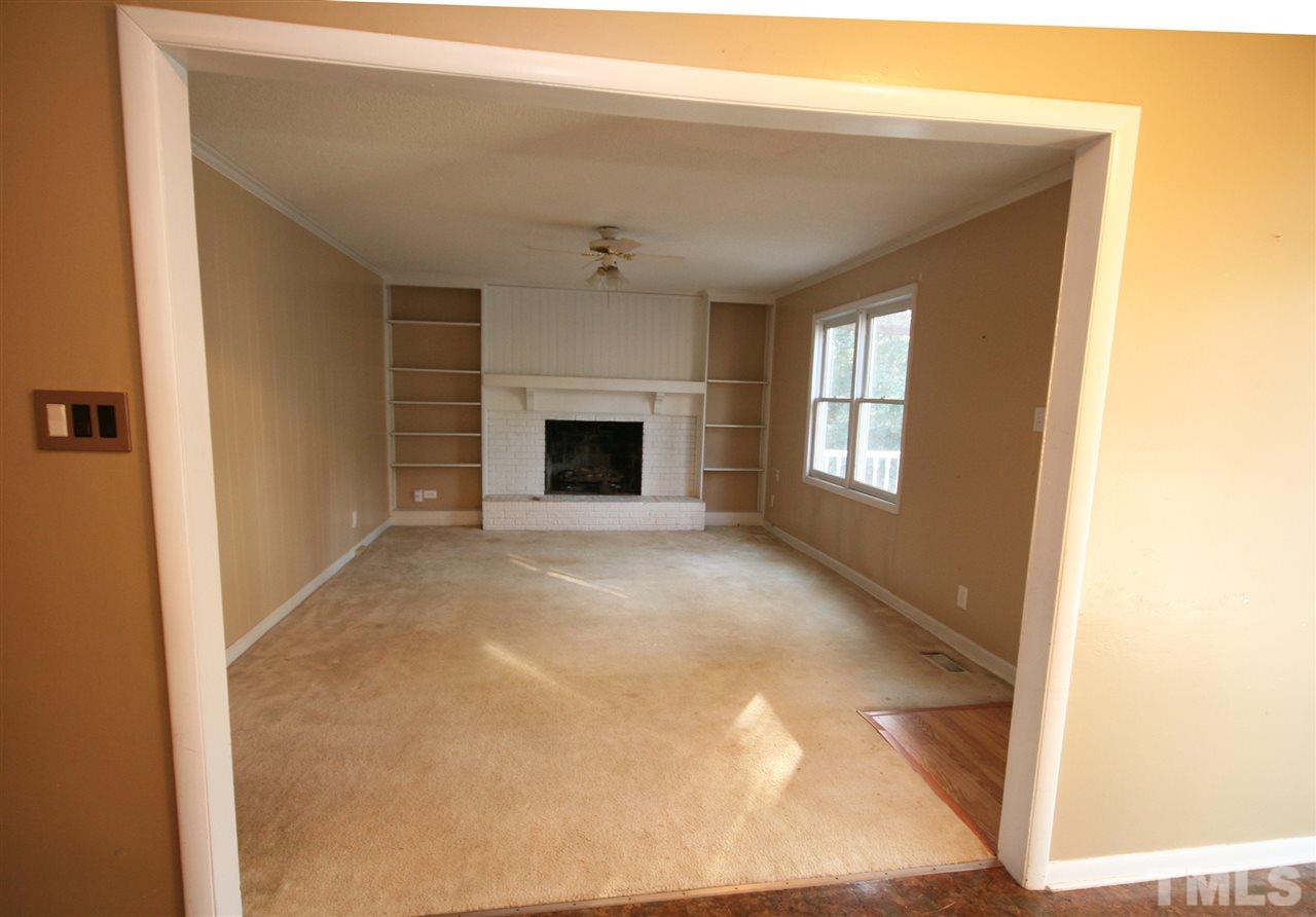 5821 Morning Forest Drive Raleigh, NC 27609 - Photo 10 of 25 a view of empty room with a fireplace