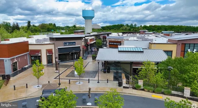 an aerial view of a house with garden space and street view