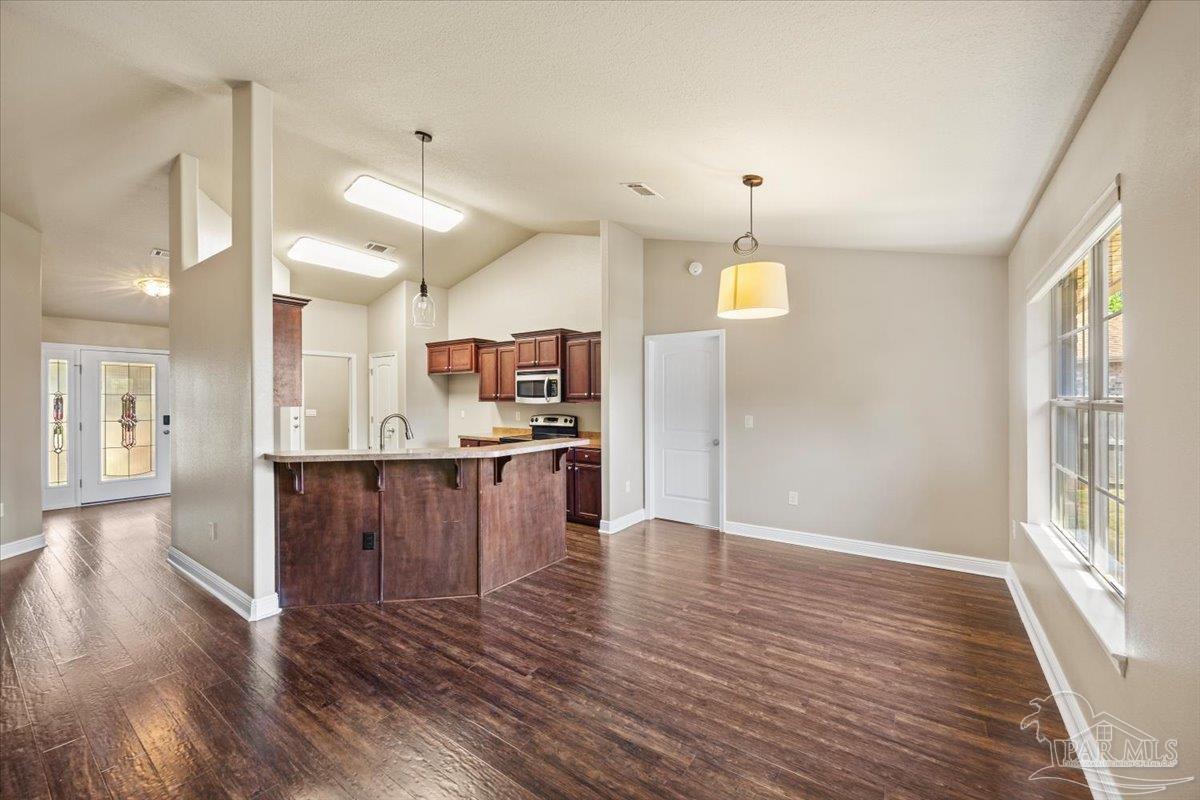 4015 Berry Circle Pace, FL 32571 - Photo 19 of 48 a view of kitchen with cabinets and wooden floor