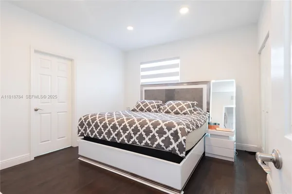 a bedroom with a bed and walk in closet with cabinet