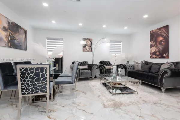 a living room with furniture and a glass door