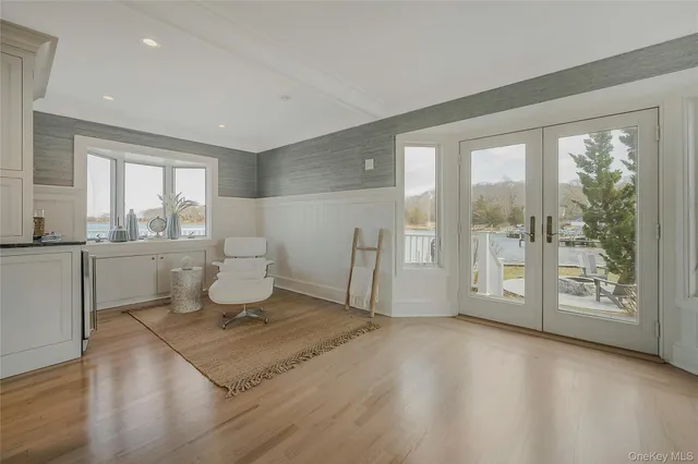 a living room with a toilet a sink and a large window