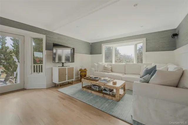 a living room with furniture and large window