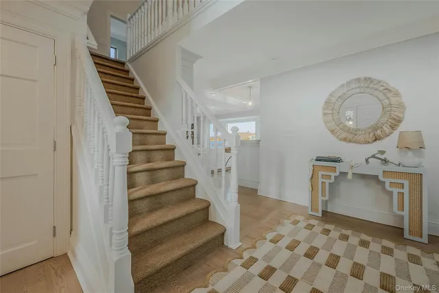 a view of a hallway with entryway wooden floor and front door