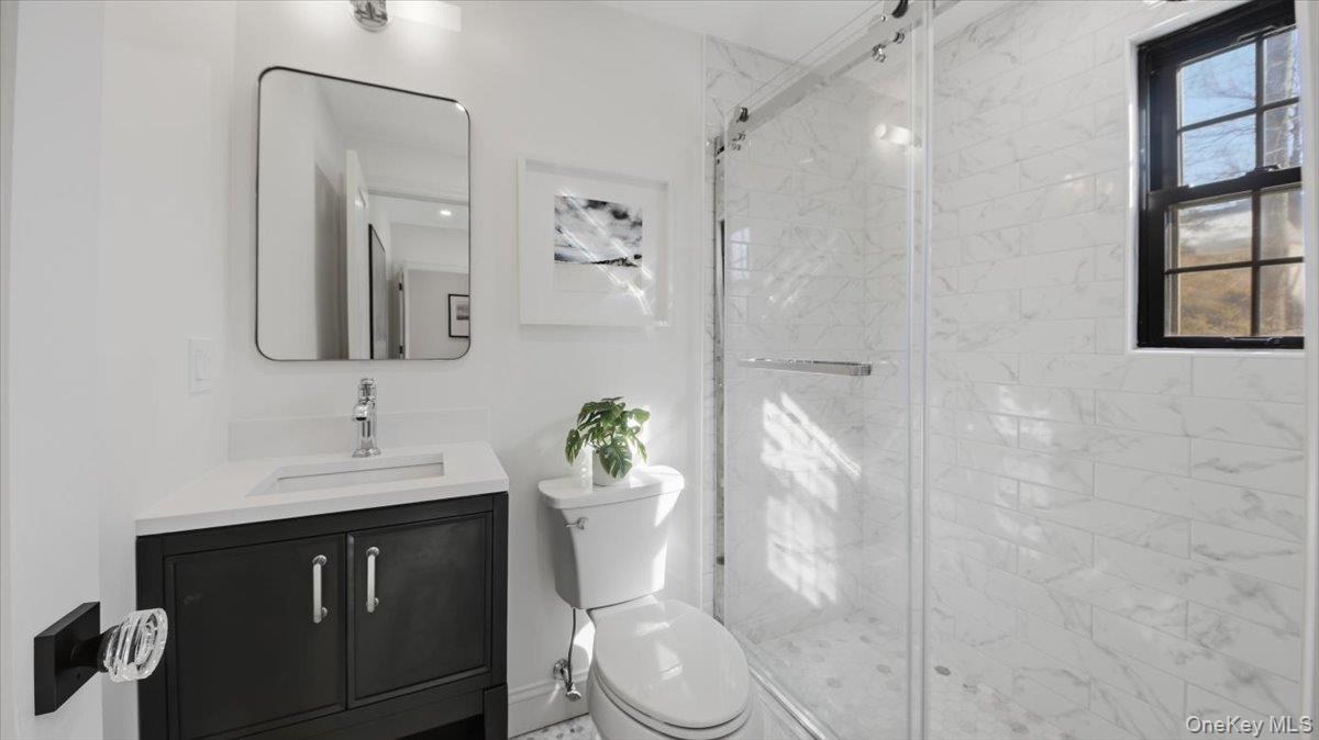 18 Lakeside Drive New Rochelle, NY 10801 - Photo 18 of 43 a bathroom with a sink vanity mirror and toilet