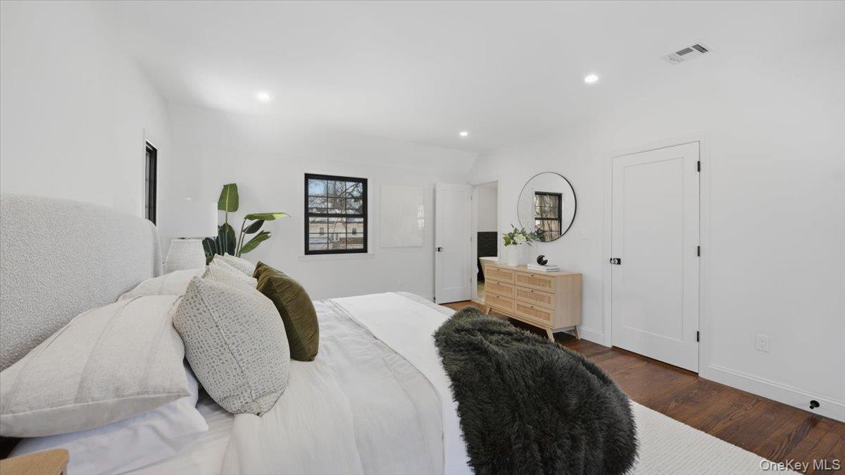 18 Lakeside Drive New Rochelle, NY 10801 - Photo 22 of 43 a bedroom with a bed and a large mirror