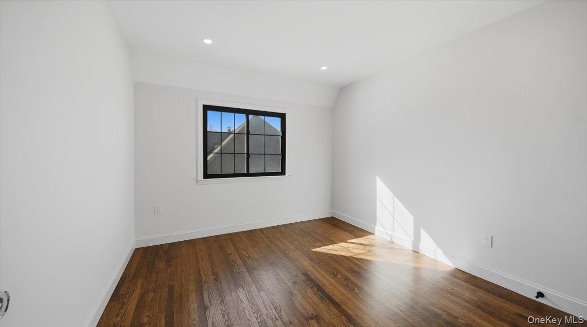 18 Lakeside Drive New Rochelle, NY 10801 - Photo 28 of 43 an empty room with wooden floor and windows