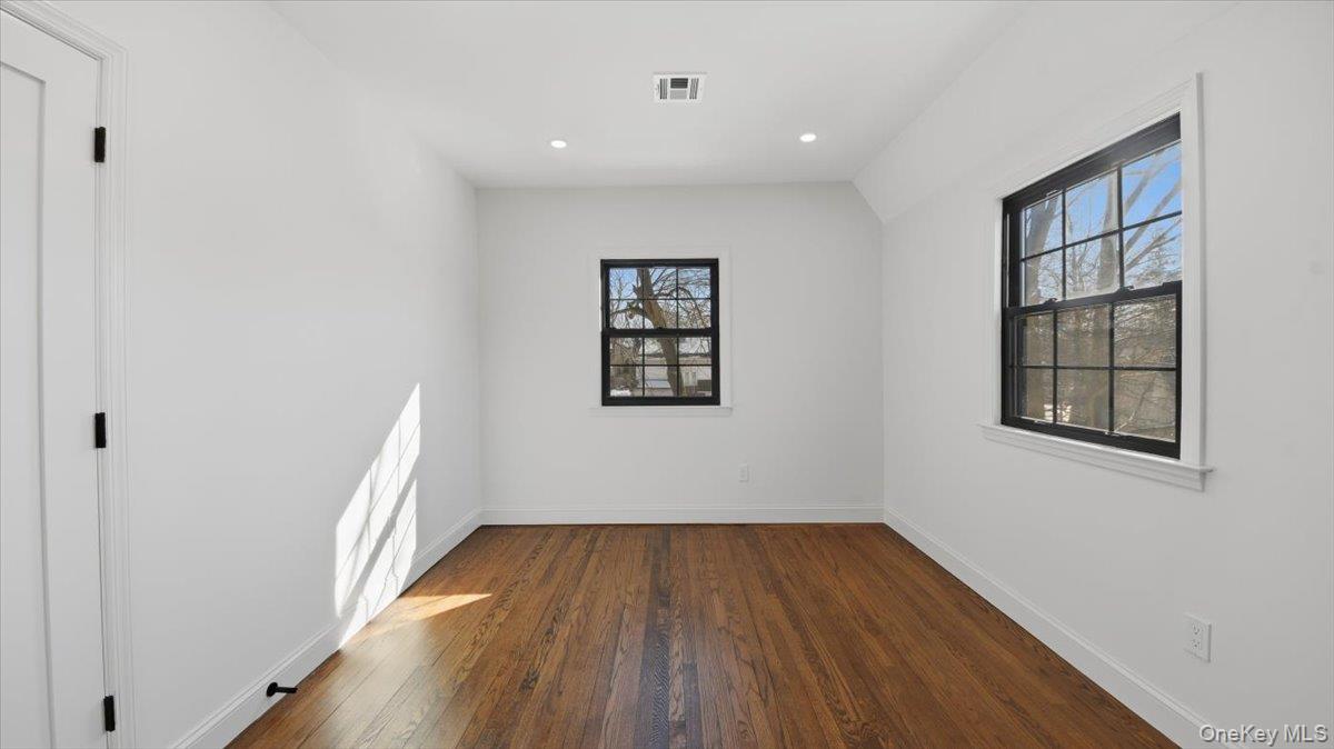 18 Lakeside Drive New Rochelle, NY 10801 - Photo 29 of 43 an empty room with wooden floor and windows