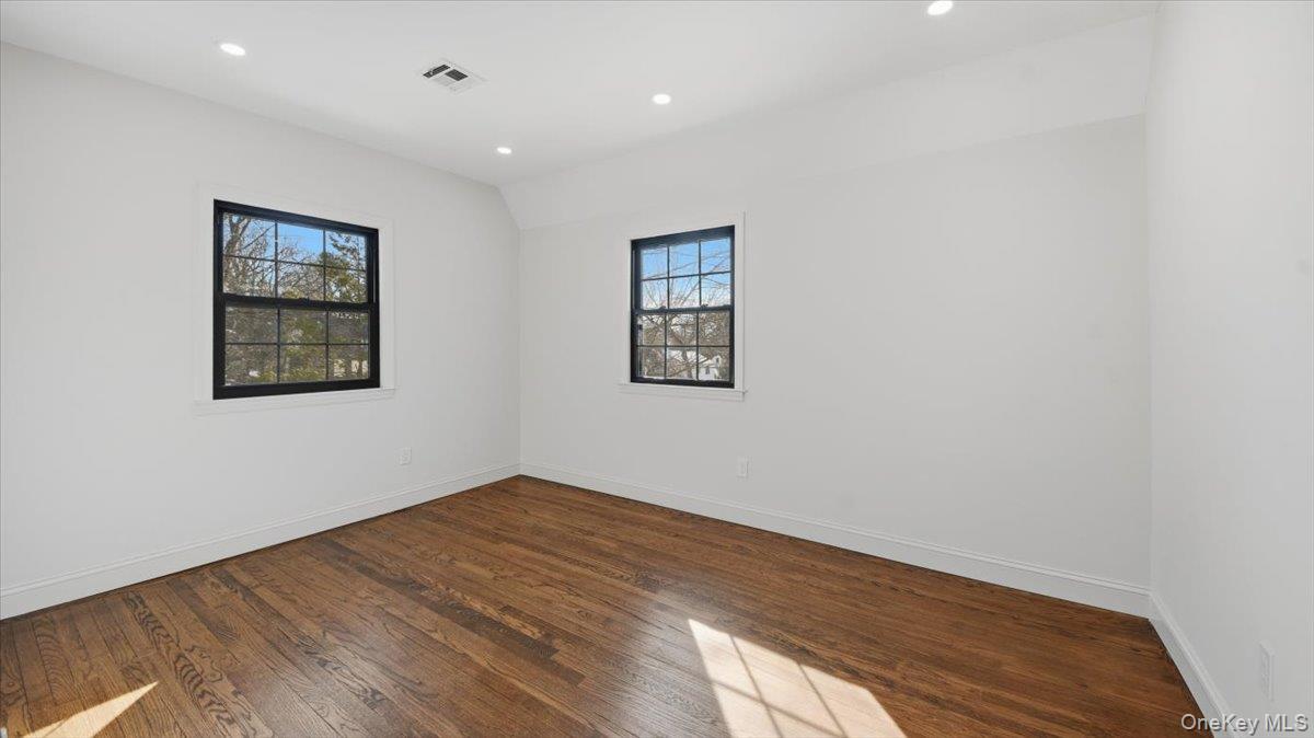 18 Lakeside Drive New Rochelle, NY 10801 - Photo 30 of 43 an empty room with wooden floor and windows