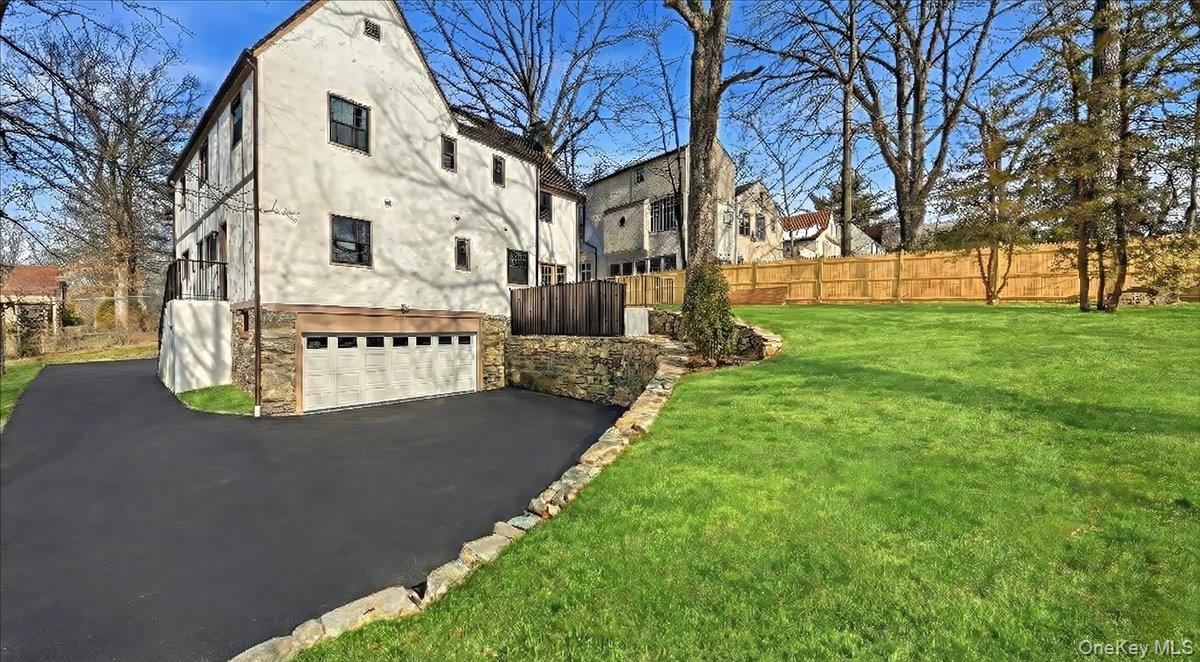 18 Lakeside Drive New Rochelle, NY 10801 - Photo 38 of 43 a view of a white house with a yard and large tree