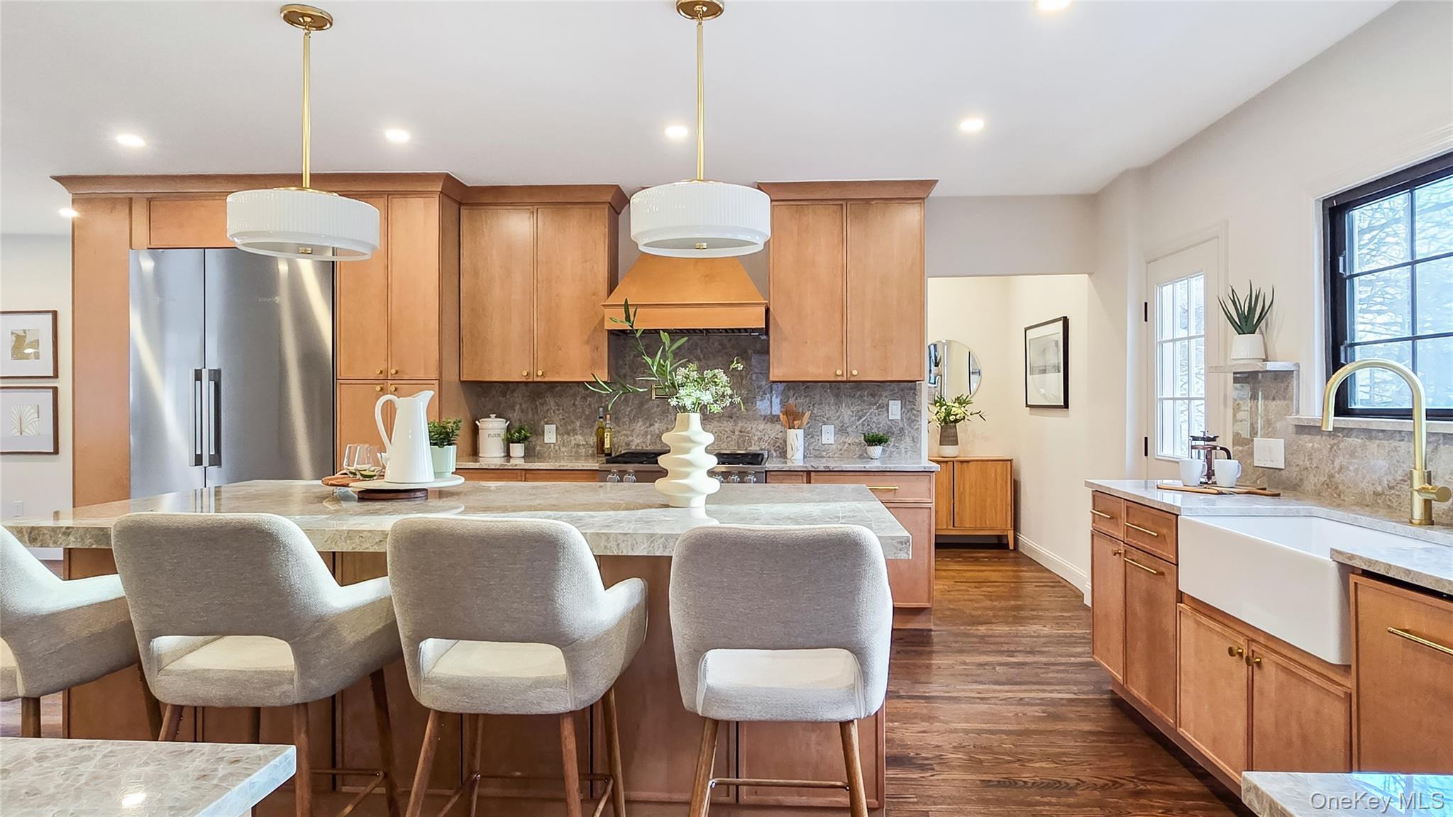 18 Lakeside Drive New Rochelle, NY 10801 - Photo 6 of 43 a large kitchen with kitchen island granite countertop a stove a sink a island a dining table and chairs