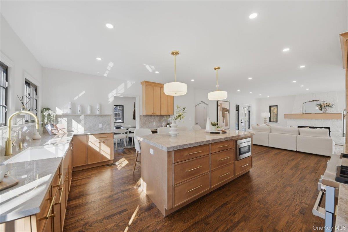 18 Lakeside Drive New Rochelle, NY 10801 - Photo 9 of 43 a large kitchen with a large counter top a sink a window and stainless steel appliances