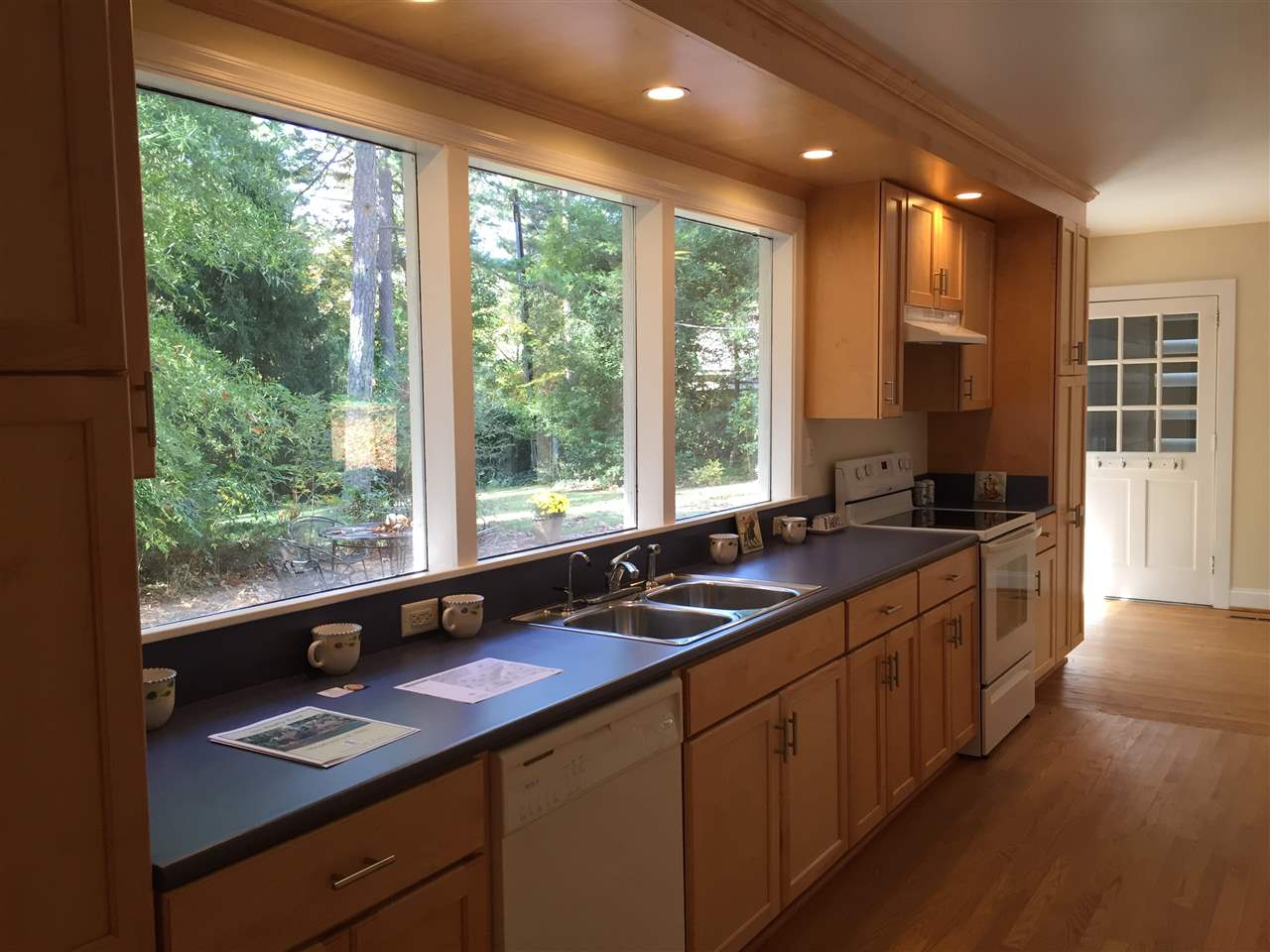 1531 Rugby Road Charlottesville, VA 22903 - Photo 7 of 49 a kitchen with a large window sink and cabinets